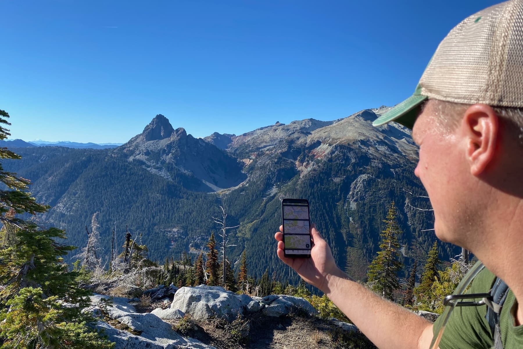 PHOTO: a paper topo map with a baseplate compass, or a phone with the map open